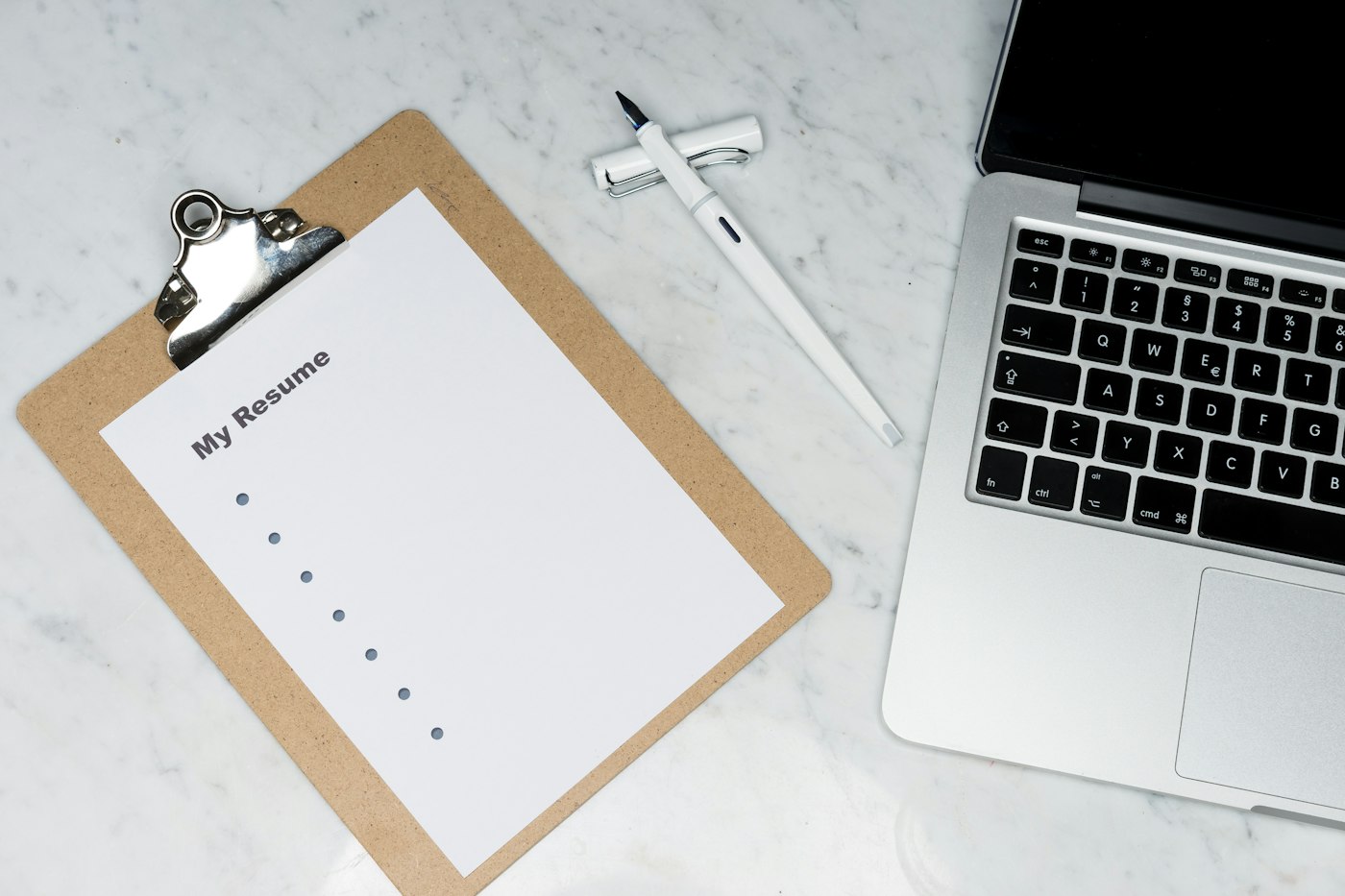 Clipboard checklist beside a laptop