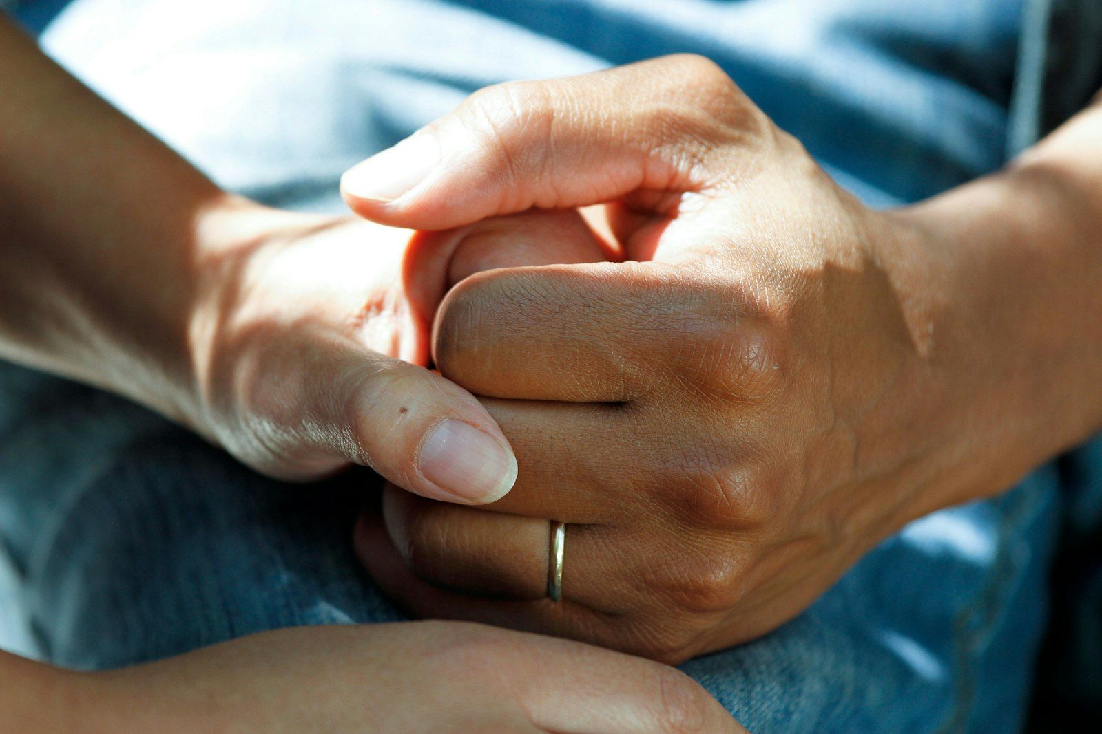 Two people holding hands in a moment of support